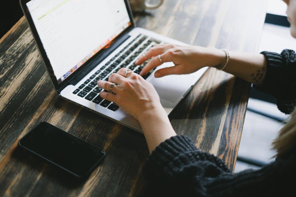 crop woman typing on laptop